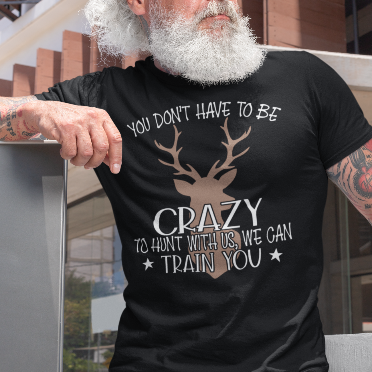 you-dont-have-to-be-crazy-to-hunt-with-us-we-can-train-you-t-shirt-mockup-of-a-trendy-middle-aged-man-with-sunglasses